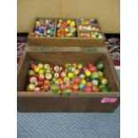 A hardwood box containing vintage wooden children's painted beads