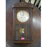 An early 20th century oak cased 8 day wall hanging clock