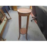 An Edwardian mahogany torchere stand