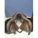 A leather horse's saddle without straps