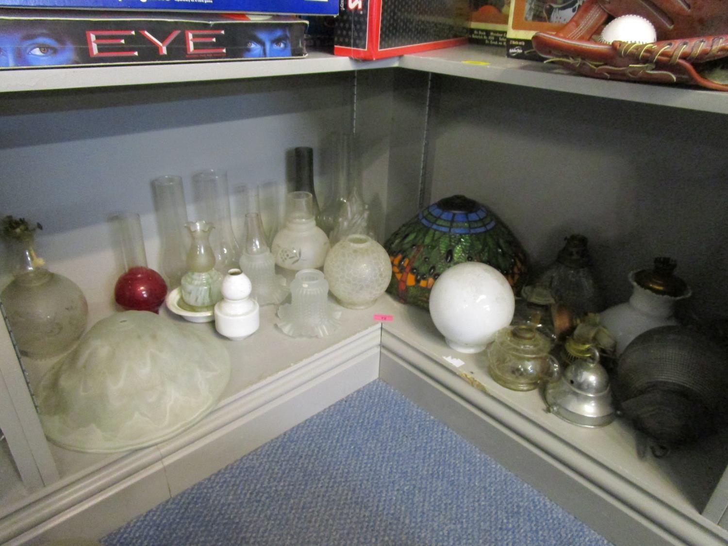 A quantity of oil lamp and table parts to include glass reservoirs and shades