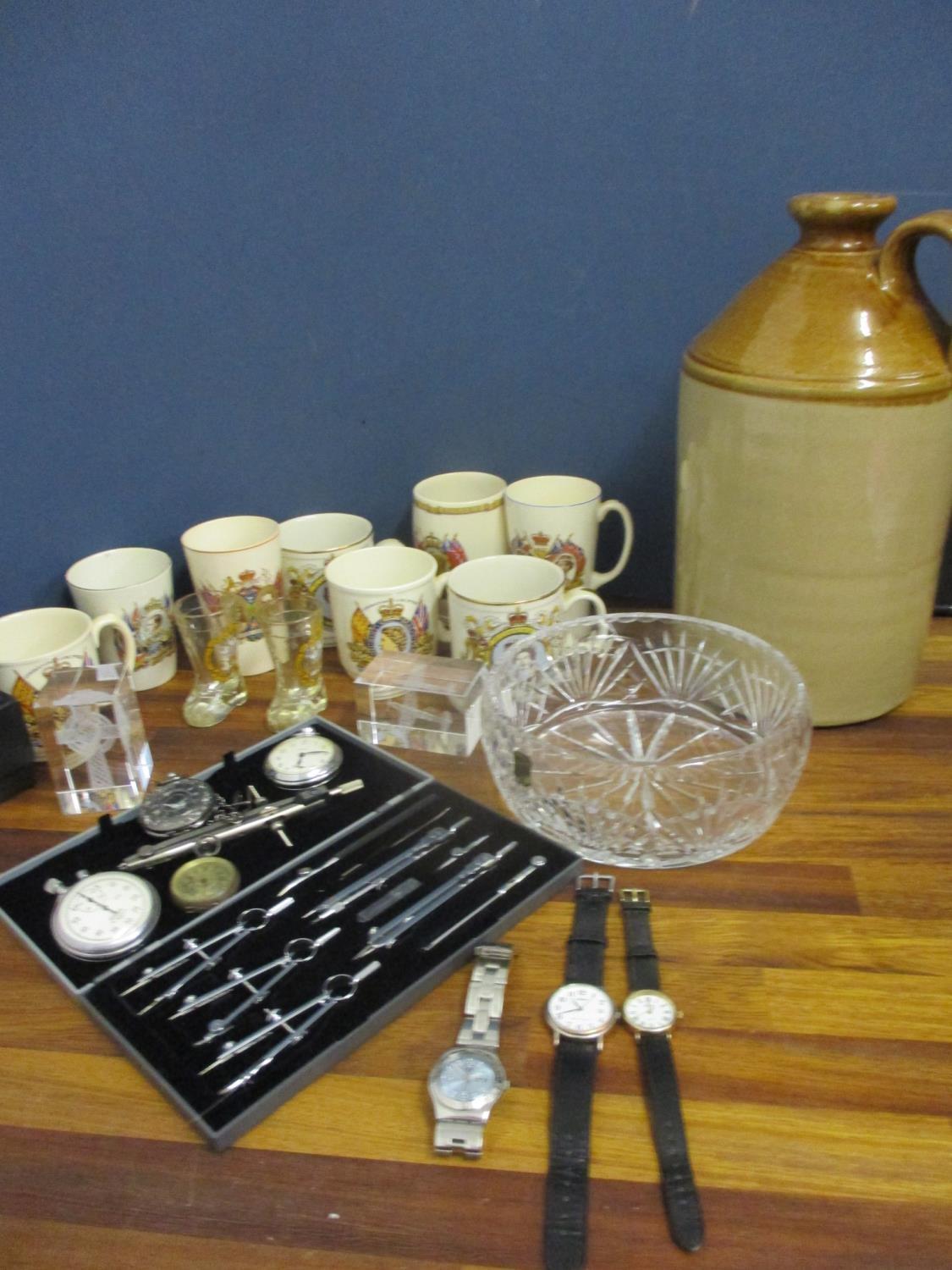 A mixed lot comprising a stoneware flagon, two glass paperweights, a cut glass fruit bowl,