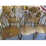 A set of five Ercol wheelback chairs to include two cavers