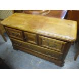 A modern French cherry wood chest of drawers having a central cupboard door revealing two small