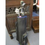 A golf bag containing golf clubs to include Wilson