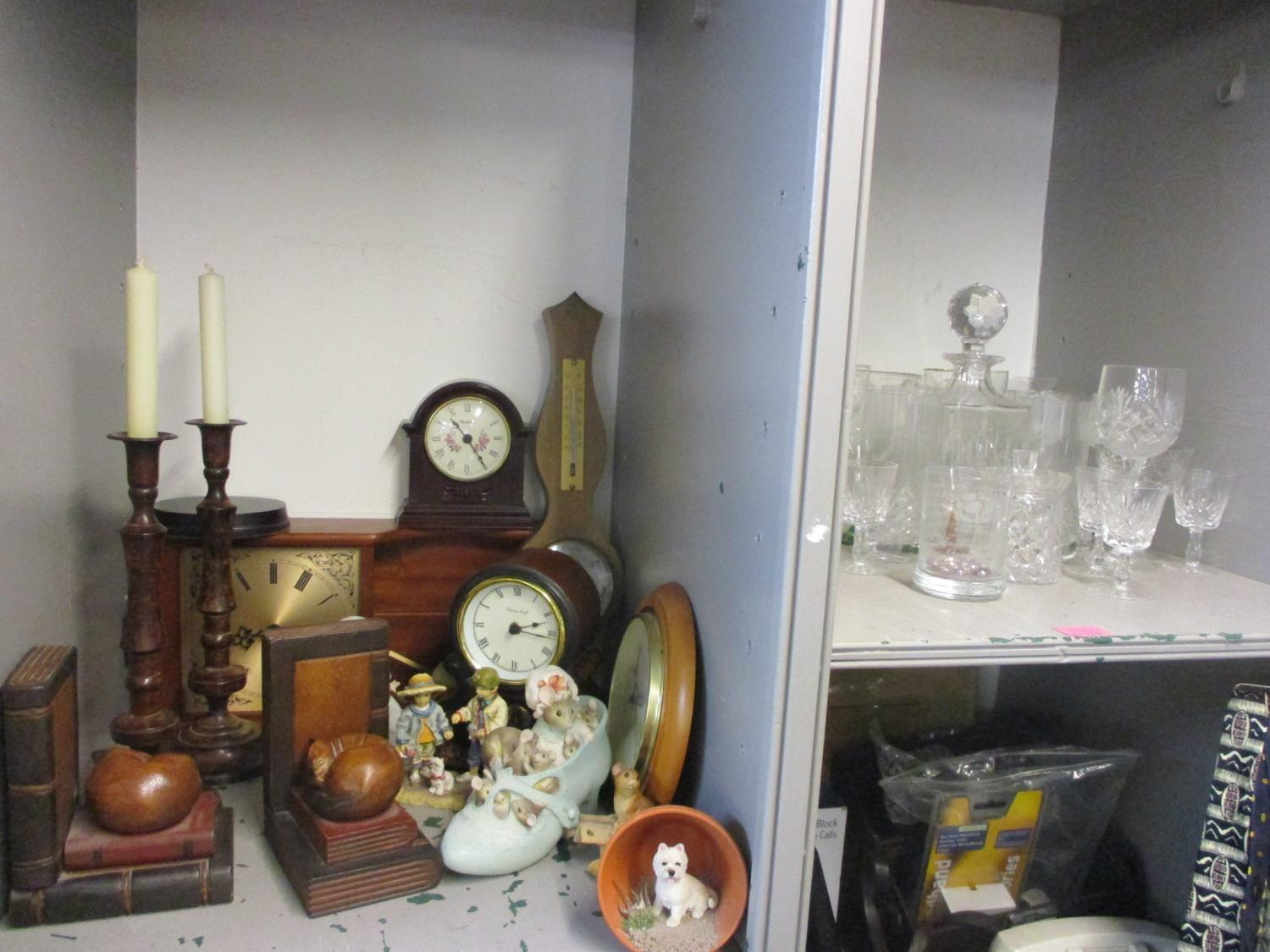 A mixed lot to include glassware, bookends, a barometer, clocks and other items