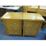 A pair of modern light oak, three drawer bedside chests, 25 1/2" x 17 3/4"