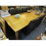 A large modern light oak dining table, 19 1/2"h x 108 1/4"w, together with ten leather high back