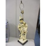 A vintage lamp in the form of a masquerade figure