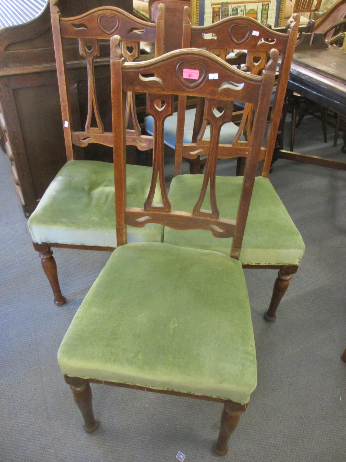 A set of three Arts & Crafts oak splat back dining chairs