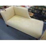 A modern beige upholstered chaise longue