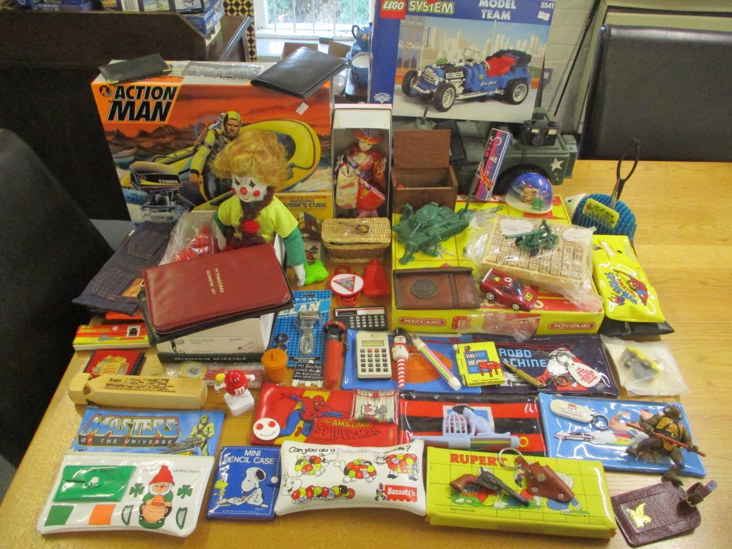 A mixed lot of toys to include an Action Man machine, toy soldiers, pencil cases and others