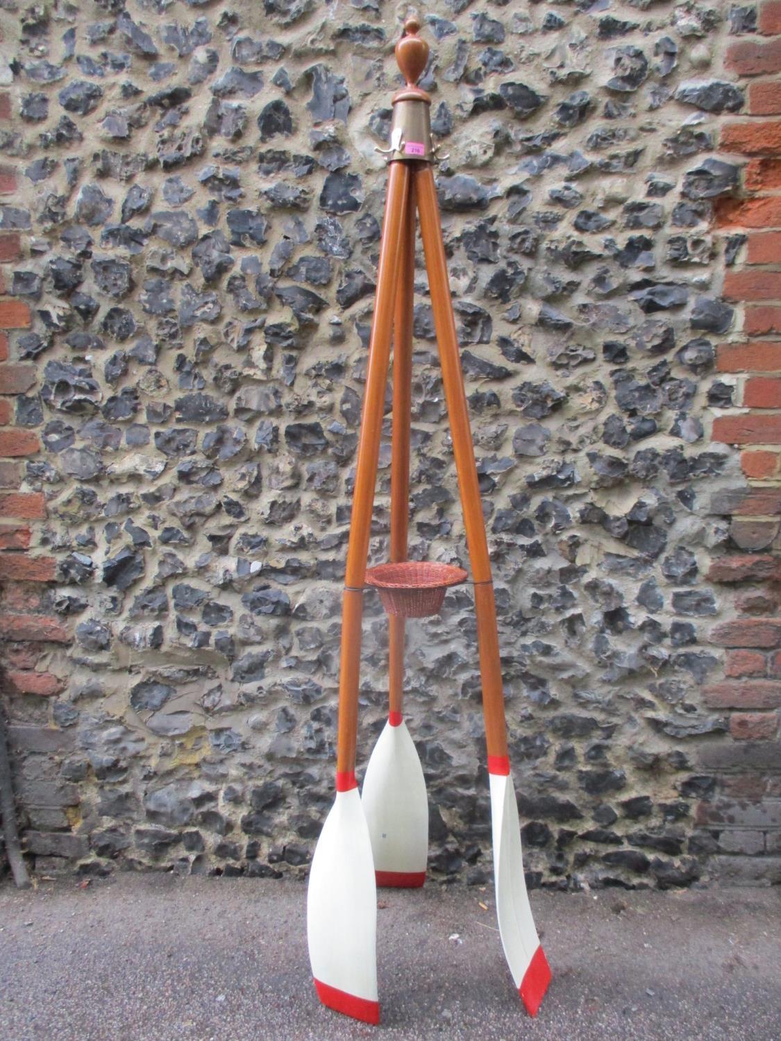 A tall coat stand in the form of three oars