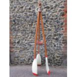 A tall coat stand in the form of three oars