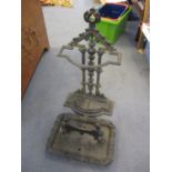 A Victorian cast iron stick/umbrella stand together with a boot scraper