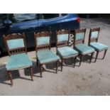 A set of six late Victorian walnut dining chairs standing on turned legs