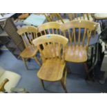 A set of four light wood lath back kitchen chairs