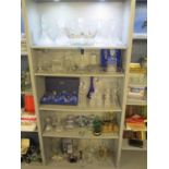 Five shelves of glassware to include decanters, drinking glasses and other items