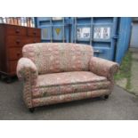 A two seater upholstered sofa circa 1920