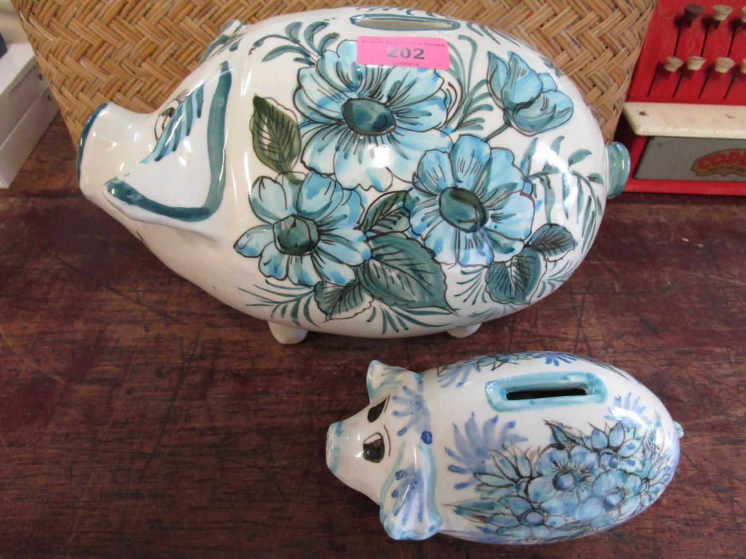 Two Maltese pottery pig money boxes