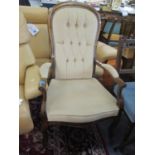 A reproduction Victorian style mahogany button back armchair on short cabriole legs