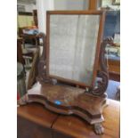 A Victorian mahogany dressing table swing mirror standing on two front claw feet