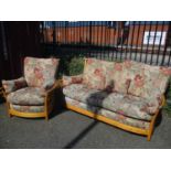 A light Ercol sofa, together with a matching armchair