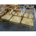 A set of six modern satinwood wishbone style chairs with rush seats