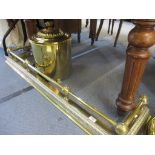 A brass fire curb, a brass lidded coal scuttle and a Corinthian capital table lamp