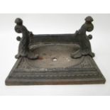 A Victorian cast iron boot scraper with twin scrolled leaf ornament, 14" h