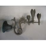 A late 19th/early 20th century patinated bronze wall candle sconce, with three sockets, supported by