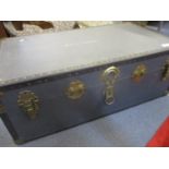 A late 20th century navy trunk with brass effect metal brackets