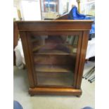 An Edwardian inlaid mahogany pier cabinet with a glazed door, on turned feet