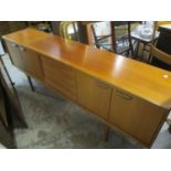 A mid 20th century 'Younger' teak sideboard having four central drawers flanked by cupboard doors