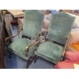 A pair of 20th century Carolean style, oak framed armchairs upholstered in green, on scrolled legs