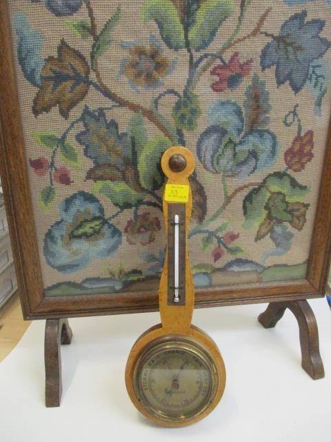 A maple cased barometer and a firescreen