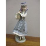 A Lladro figure of a continental girl holding a barrel of flowers