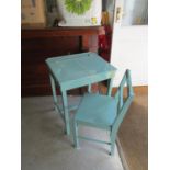 A vintage green painted child's desk and chair