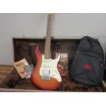 A Yamaha Pacifier electric guitar in a wood effect, together with two guitar books, a guitarist Rock