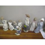 Eight Noa porcelain figures to include a girl holding a lamb, an angel and others