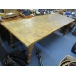 A large pitch pine kitchen table on turned legs 30 1/2" x 95 1/4" x 34"
