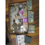 A quantity of British, foreign coinage and banknotes to include commemorative Churchill coins,