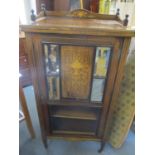 A late Victorian rosewood music cabinet having marquetry inlay, mirrored glass panels, four fitted