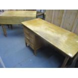 A mid 20th century oak desk, together with an early 20th century pine kitchen table having drop leaf