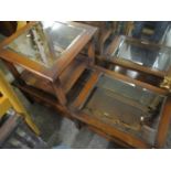 A reproduction walnut finished two tier glass topped coffee table and a matching occasional table