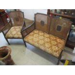 An early 20th century mahogany Bergere two person sofa and matching chair