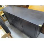 A modern black painted sideboard having three central drawers flanked by two cupboard doors, 35" h x