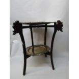 An early 20th century Chinese table with a hardwood folding stand, carved with dragons heads,