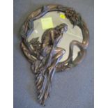 A reproduction Art Nouveau wall hanging mirror in the form of a nude female amongst a floral design,