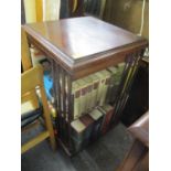 An Edwardian swivel bookcase 33 1/2"h x 19"w containing mixed books to include War-related books